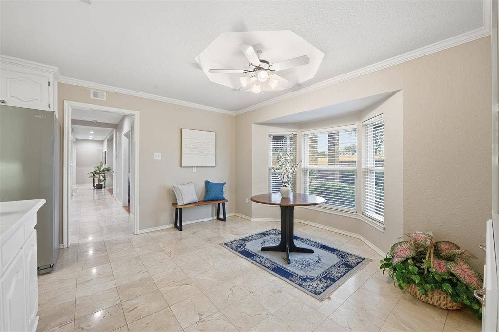 4424 Westridge Avenue, Fort Worth, TX 76116 Bay window with blinds, tile flooring, recessed ceiling with a ceiling fan, and crown molding