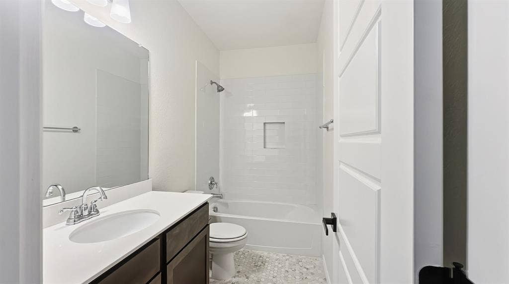 3129 Grayslick Avenue, Celina, TX 75009 Dark wood-finish vanity with white countertop and oval sink