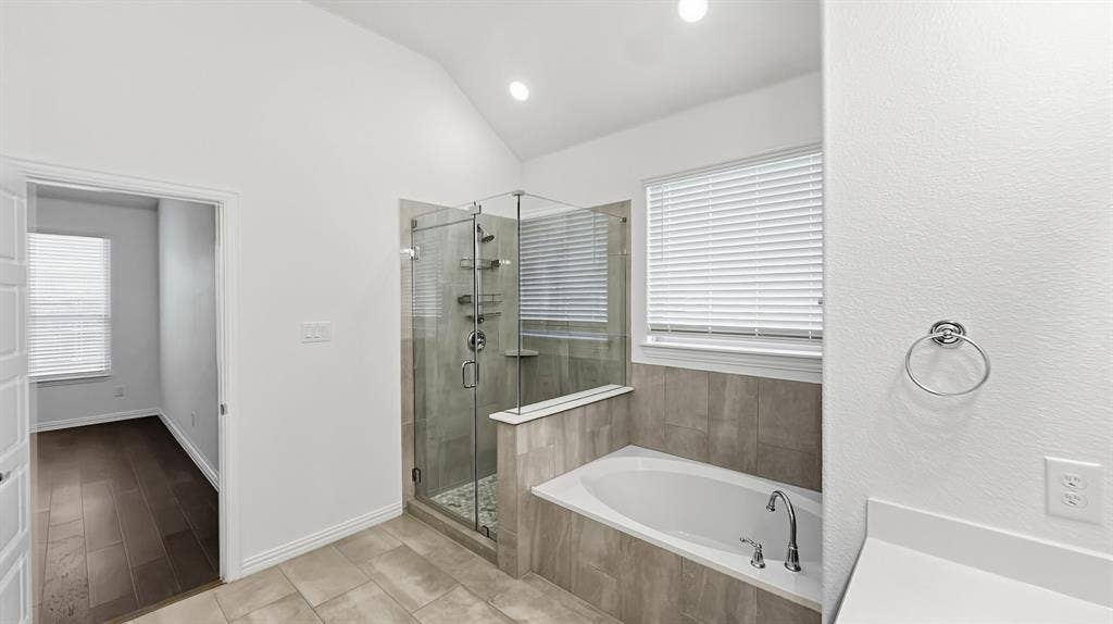 3129 Grayslick Avenue, Celina, TX 75009 Spacious bathroom featuring a glass-enclosed shower, built-in soaking tub, and vaulted ceiling