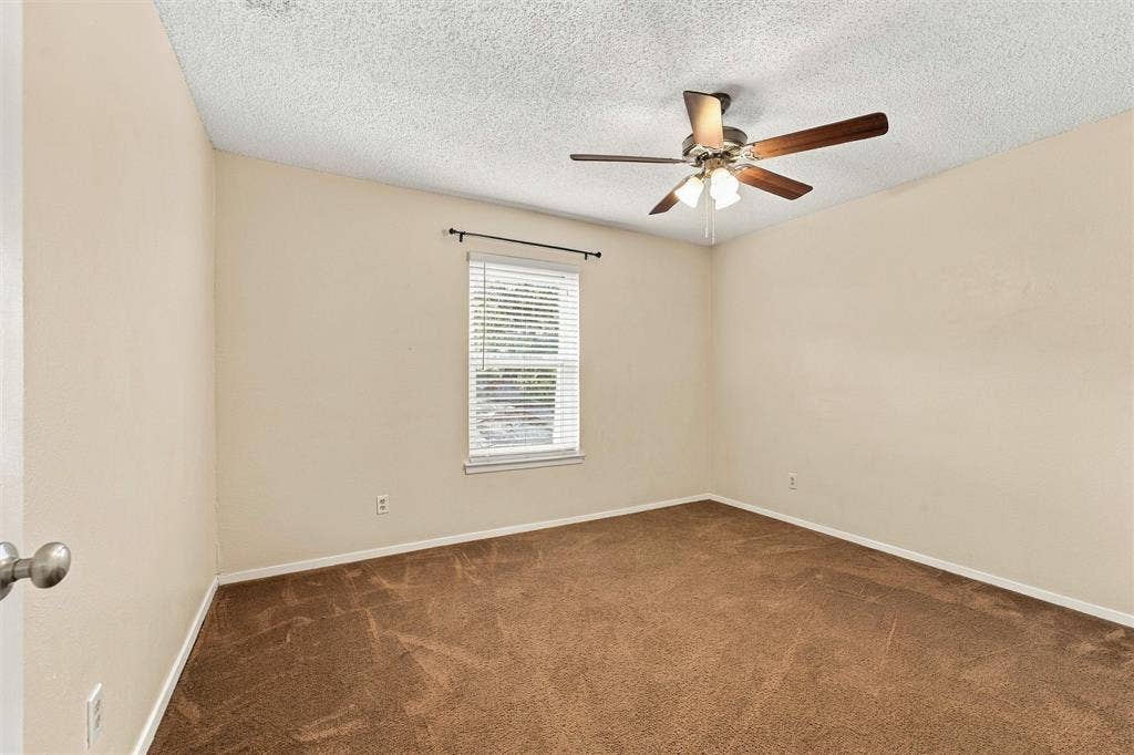 410 W Franklin Street, #5, Waxahachie, TX 75165 Recessed window with blinds, ceiling fan with light fixture, and brown carpet flooring