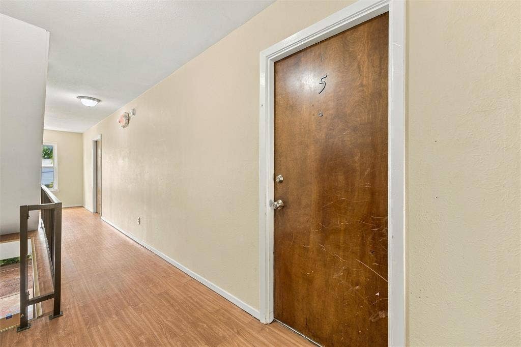 410 W Franklin Street, #5, Waxahachie, TX 75165 Wood-finish flooring in the hallway