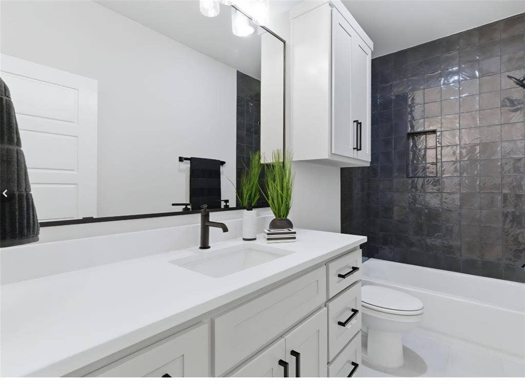 2608 Southbay, Northlake, TX 76226 White vanity with black hardware, integrated sink, and matte black faucet
