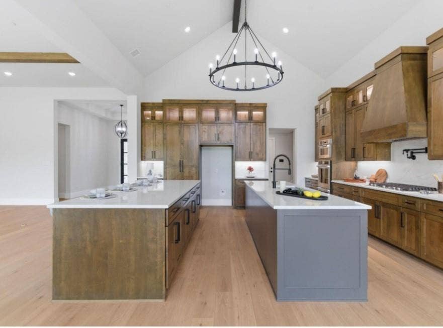 2608 Southbay, Northlake, TX 76226 Gourmet kitchen featuring dual islands, natural wood cabinetry, a vaulted ceiling, and recessed lighting