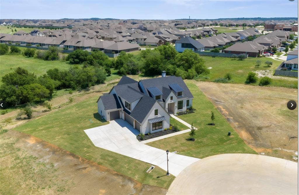 2608 Southbay, Northlake, TX 76226 Stone and siding exterior with a dark-pitched roof, featuring multiple gables and dormer windows