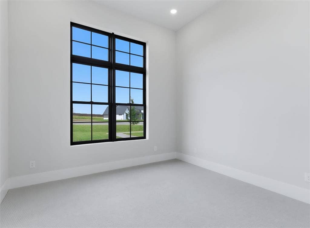 2608 Southbay, Northlake, TX 76226 Large window with black grid, recessed ceiling lighting, light gray wall paint, and light gray carpet flooring