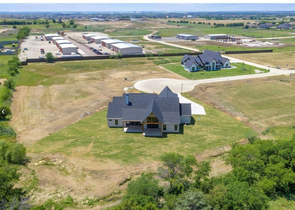 2608 Southbay, Northlake, TX 76226 Modern-style residence with a dark-pitched roof, light-toned exterior, and an expansive concrete driveway