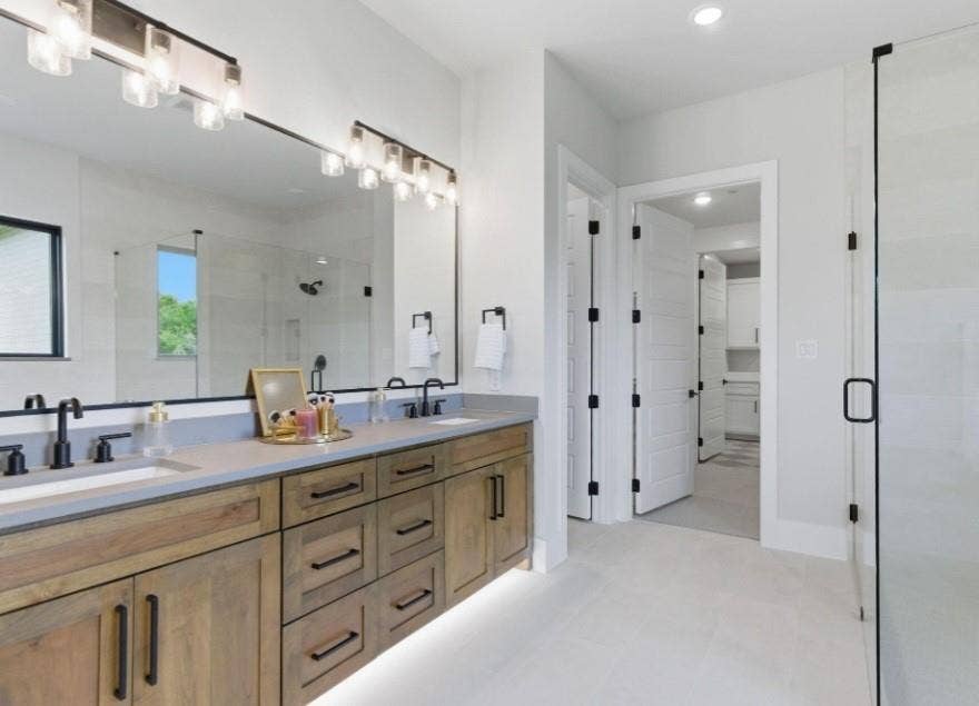 2608 Southbay, Northlake, TX 76226 Dual vanity with wood-finish cabinetry and undermount lighting