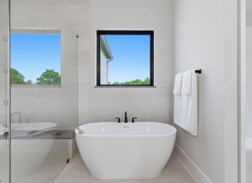 2608 Southbay, Northlake, TX 76226 Freestanding soaking tub with a floor-mounted matte black faucet