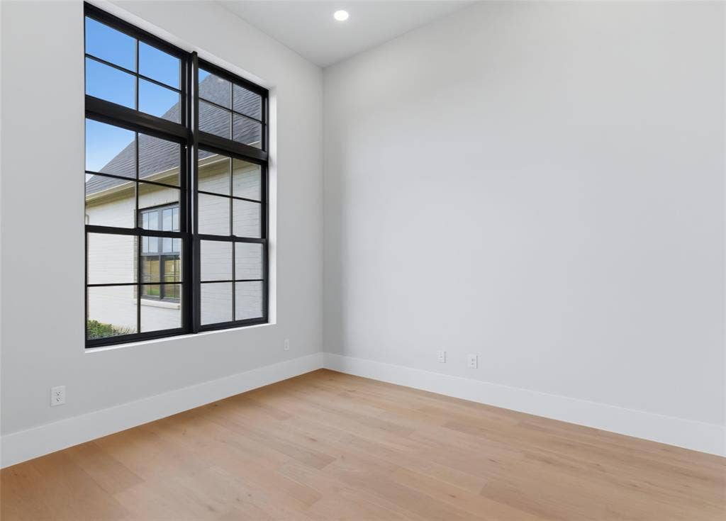 2608 Southbay, Northlake, TX 76226 Expansive window with black grid panes, recessed ceiling lighting, light wood-finish flooring, and crisp white walls