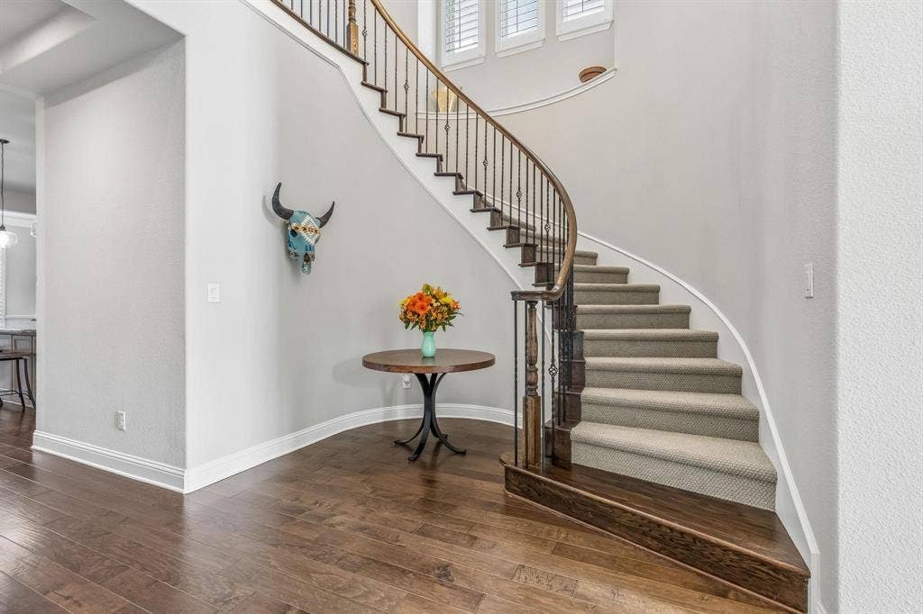7342 Shoestring Drive, Frisco, TX 75036 Elegant winding staircase creates a stunning focal point and grand first impression.