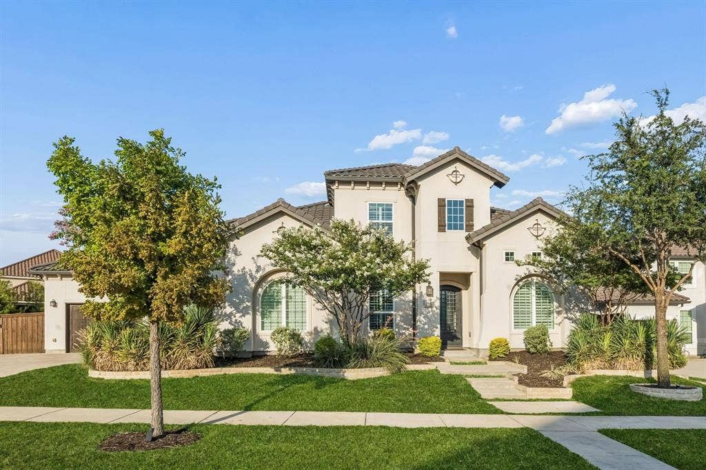 7342 Shoestring Drive, Frisco, TX 75036 Elegant stucco exterior with a classic tile roof creates a stunning first impression.