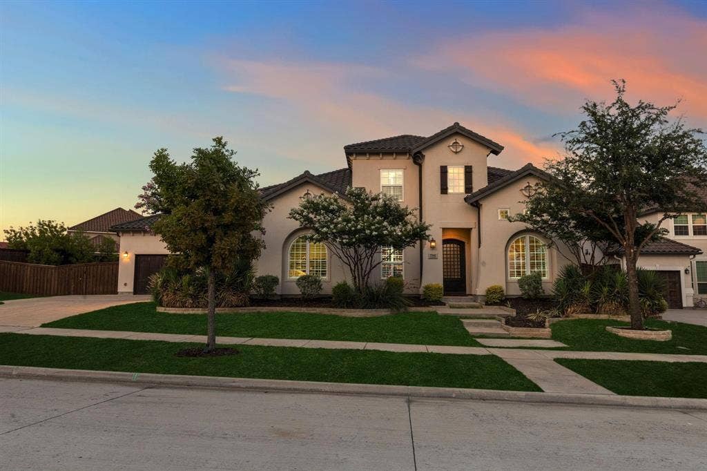 7342 Shoestring Drive, Frisco, TX 75036 Stucco exterior with a tiled roof, arched windows, and dark wood shutters