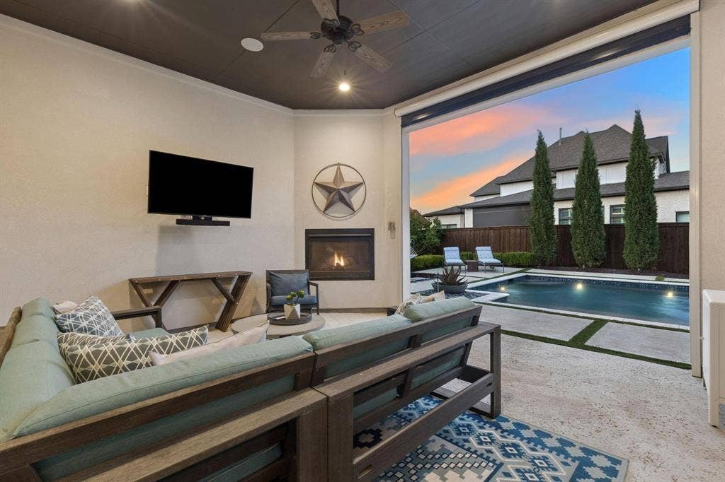 7342 Shoestring Drive, Frisco, TX 75036 Covered outdoor living area with a built-in fireplace, ceiling fan, and recessed lighting