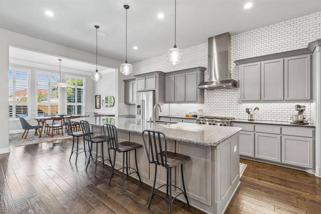 7342 Shoestring Drive, Frisco, TX 75036 Spacious open kitchen featuring abundant cabinetry, including additional storage beneath the breakfast bar.