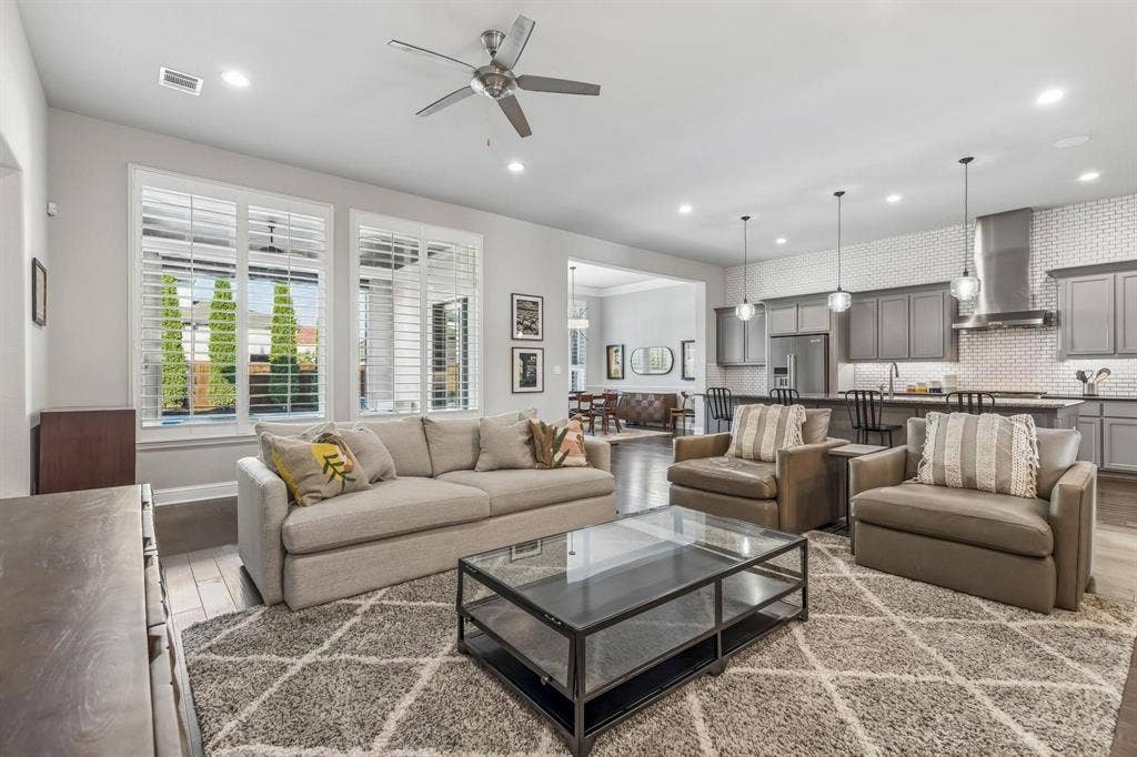7342 Shoestring Drive, Frisco, TX 75036 Inviting living area featuring beautiful plantation shutters that add timeless elegance and natural light control.