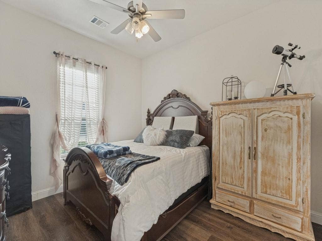 Wood-finish flooring, light-colored walls, window with blinds, and ceiling fan with lighting