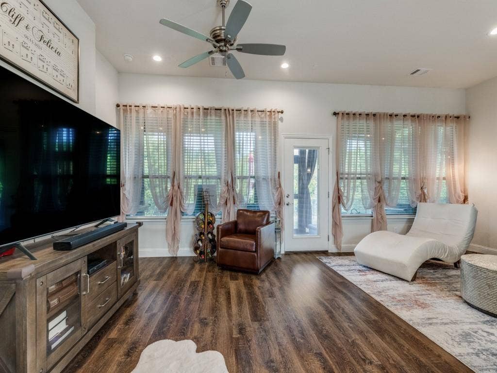 Wood-finish flooring, multiple windows with blinds, recessed lighting, and a ceiling fan