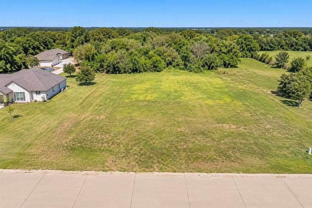3926 Vista Oak Drive, Royse City, TX 75189 Expansive undeveloped lot with a partial concrete curb and street frontage