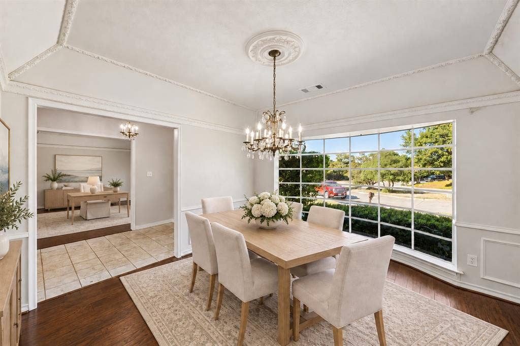 10322 White Rock Place, Dallas, TX 75238 Elegant formal dining room off the entry, featuring hardwoods and a large bay window and a coffered ceiling. This photo is virtually staged.