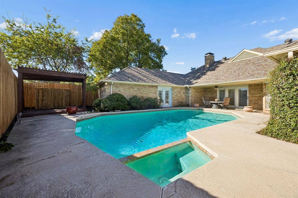 10322 White Rock Place, Dallas, TX 75238 Inviting swimming pool with integrated spa, pergola, and new fence.