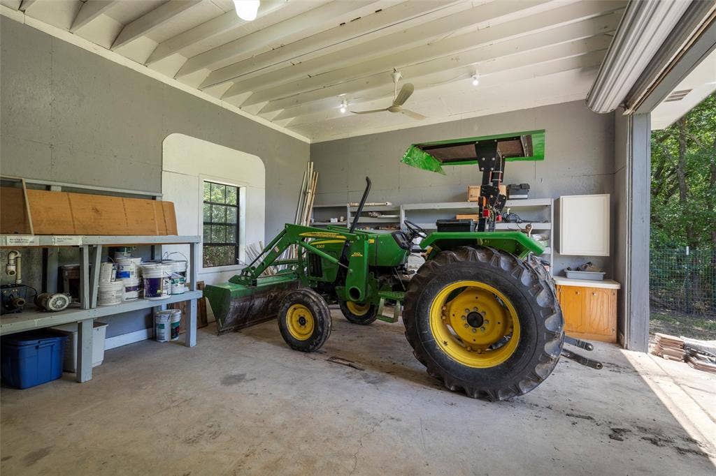2029 Speegleville Road, Woodway, TX 76712 Concrete flooring garage with an exposed beam ceiling, recessed lighting, and a roll-up garage door