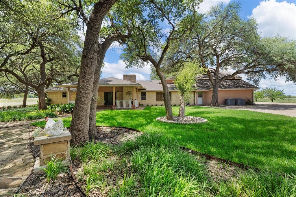 2029 Speegleville Road, Woodway, TX 76712 Expansive lawn with mature trees and a stone-clad entrance pillar