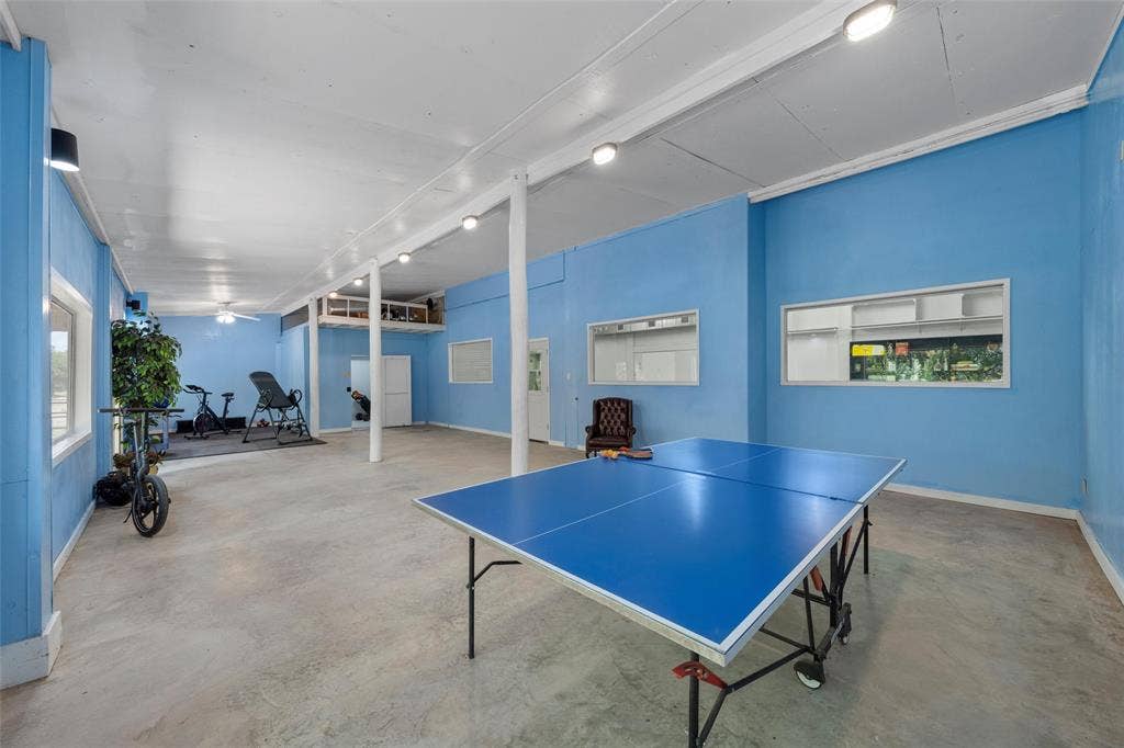 2029 Speegleville Road, Woodway, TX 76712 Spacious room featuring light blue walls, concrete flooring, recessed lighting, and support columns