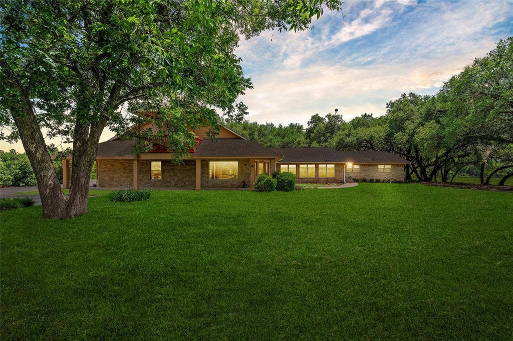 2029 Speegleville Road, Woodway, TX 76712 Expansive front lawn with mature trees, brick exterior, covered front porch, and multiple windows