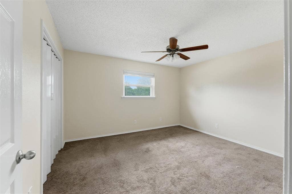 401 N 7th Street, #C, Midlothian, TX 76065 Neutral wall paint, carpet flooring, a ceiling fan, and a window