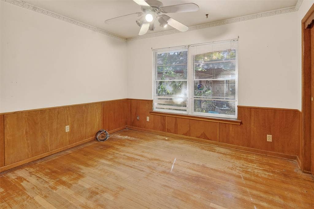 2024 Blake Avenue, Dallas, TX 75228 Wood-finish flooring, wood paneling, and a ceiling fan with integrated lighting