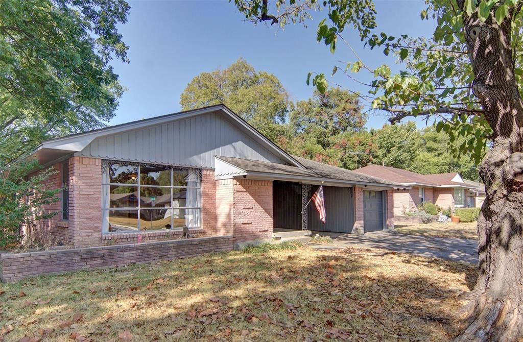 2024 Blake Avenue, Dallas, TX 75228 Brick exterior with two garage doors and a prominent front window