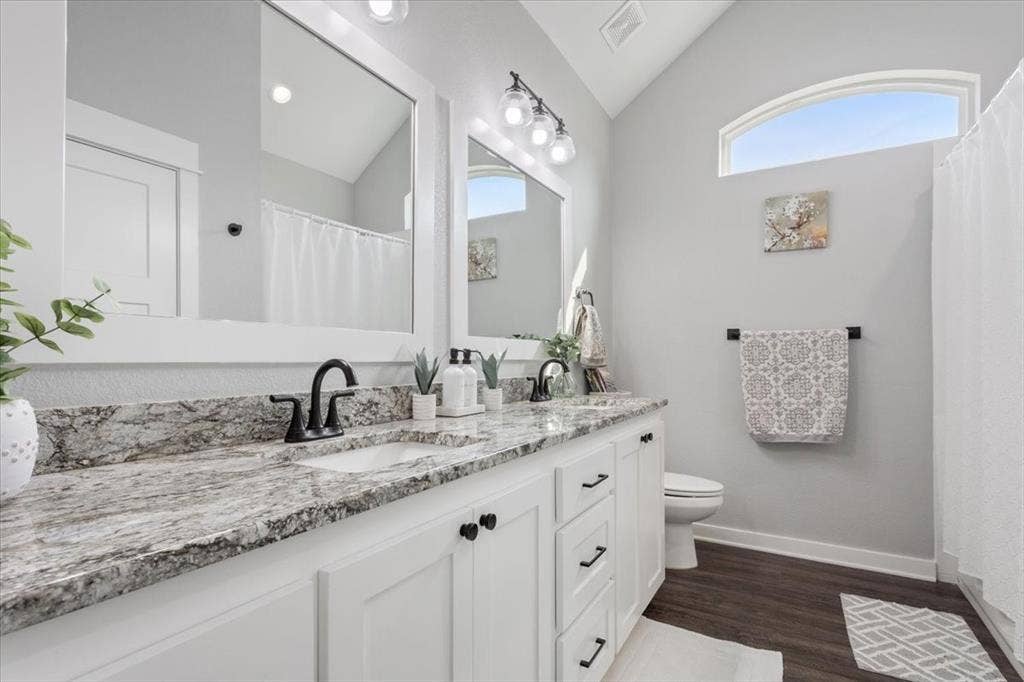 10305 Creekside Lane, Waco, TX 76712 Dual vanity with integrated sinks, granite-style countertop, and matte black fixtures