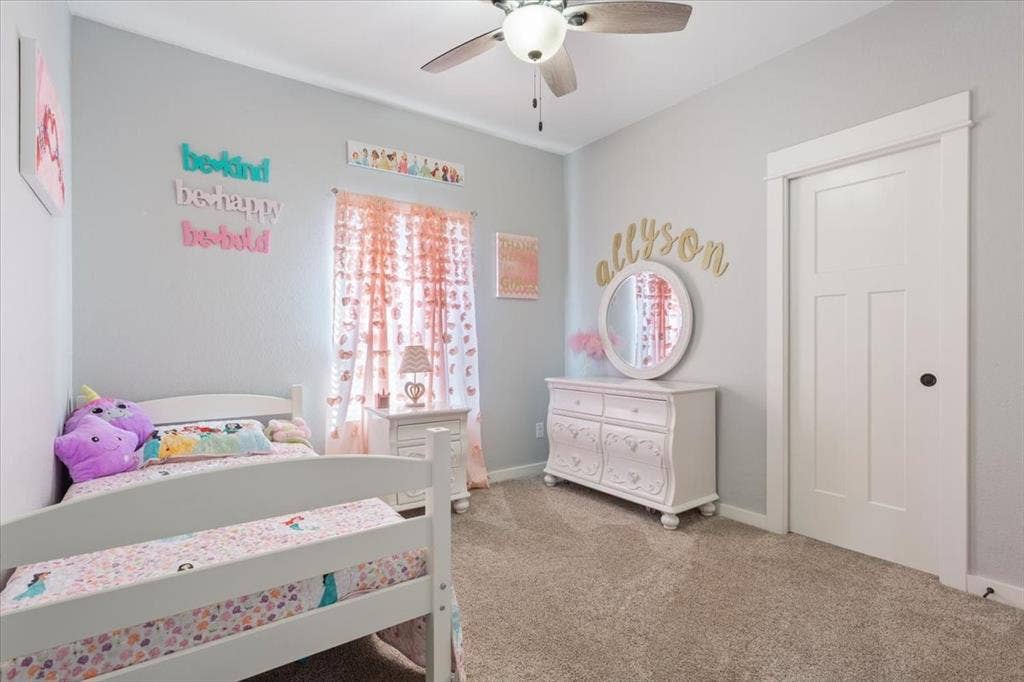 10305 Creekside Lane, Waco, TX 76712 Carpeted flooring, ceiling fan, white paneled door with dark hardware, and light-colored walls