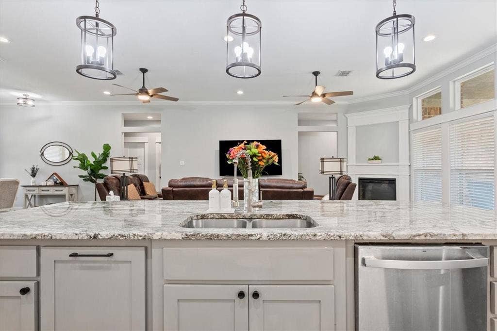 10305 Creekside Lane, Waco, TX 76712 Spacious kitchen island featuring a dual basin sink and stone-finish countertop