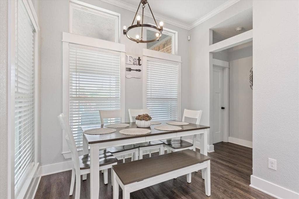 10305 Creekside Lane, Waco, TX 76712 Recessed dining space featuring a contemporary chandelier, wood-finish flooring, and crown molding