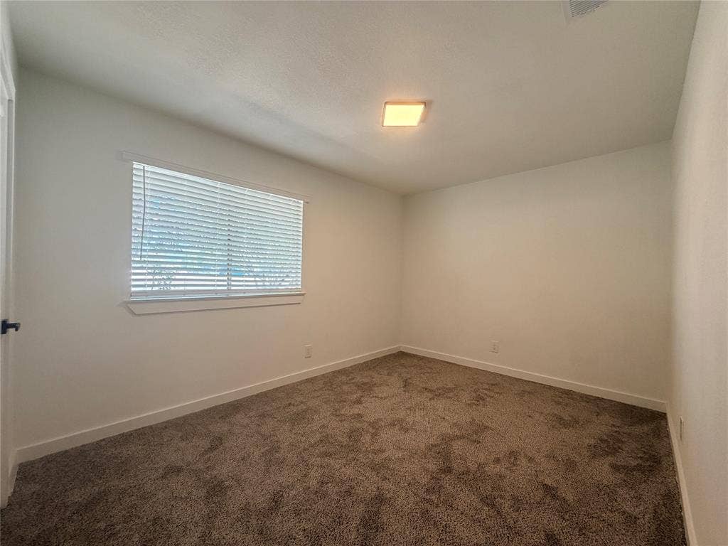 1424 E Parker Road, Plano, TX 75074 Wall-to-wall carpeting, square ceiling light fixture, white interior walls, and a window with blinds