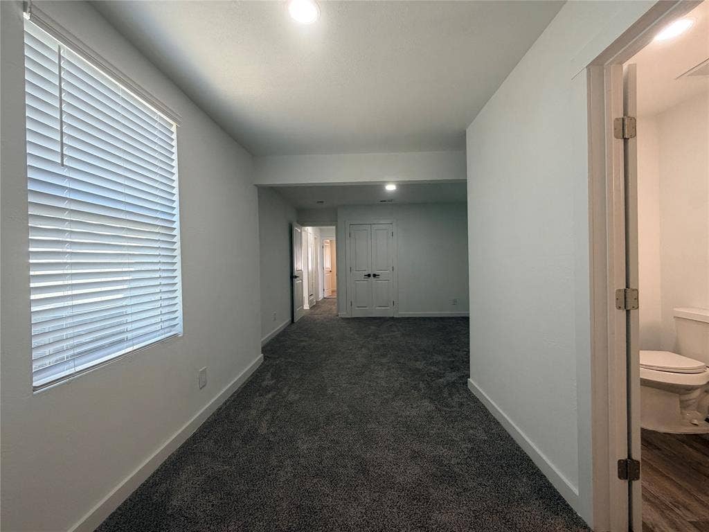 1424 E Parker Road, Plano, TX 75074 Soft gray carpeting, white walls, recessed lighting, white window blinds, and a white toilet with wood-finish flooring