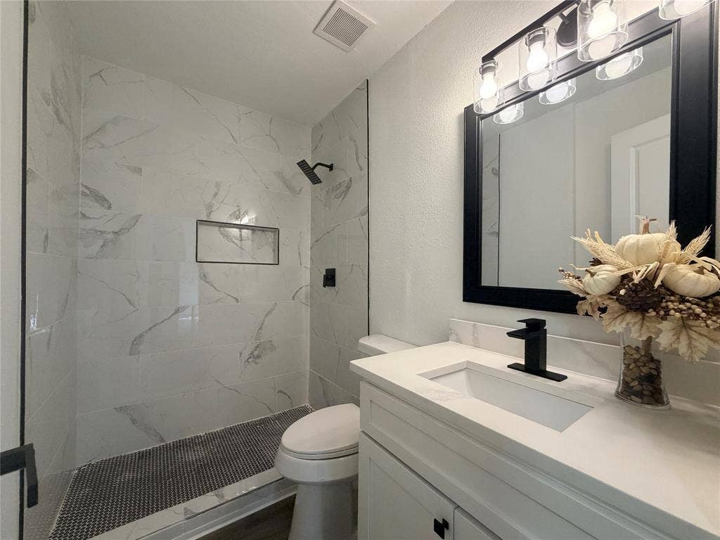 1424 E Parker Road, Plano, TX 75074 Walk-in shower with large format tile surround and integrated niche