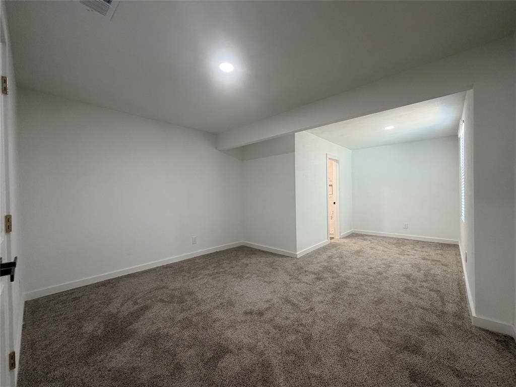 1424 E Parker Road, Plano, TX 75074 Recessed lighting illuminates the carpeted flooring and white painted walls