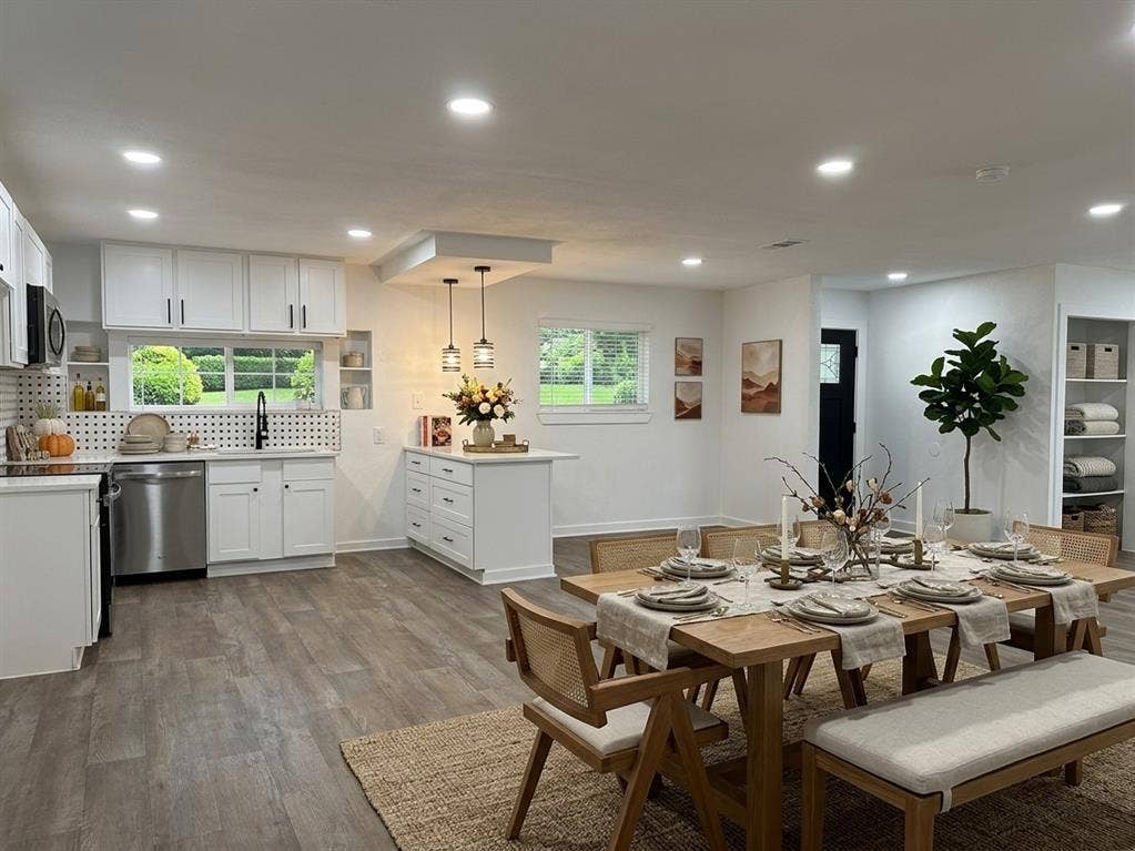 1424 E Parker Road, Plano, TX 75074 Open-concept living area featuring wood-finish flooring, recessed lighting, and a kitchen with white cabinetry and stainless steel appliances