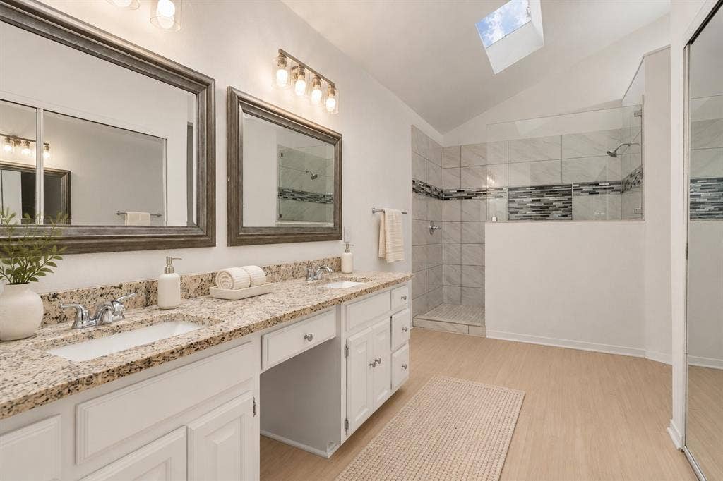 2713 Belmeade Drive, Carrollton, TX 75006 Primary bath with double vanity and walk-in shower. Virtually staged.