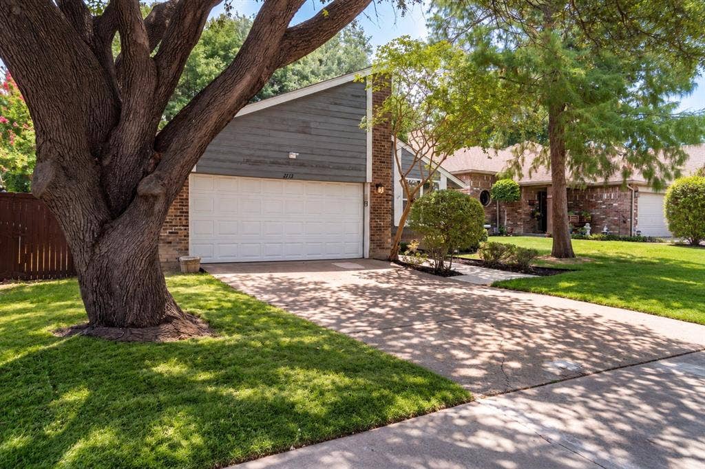 2713 Belmeade Drive, Carrollton, TX 75006 Front of the home with a two-car garage.