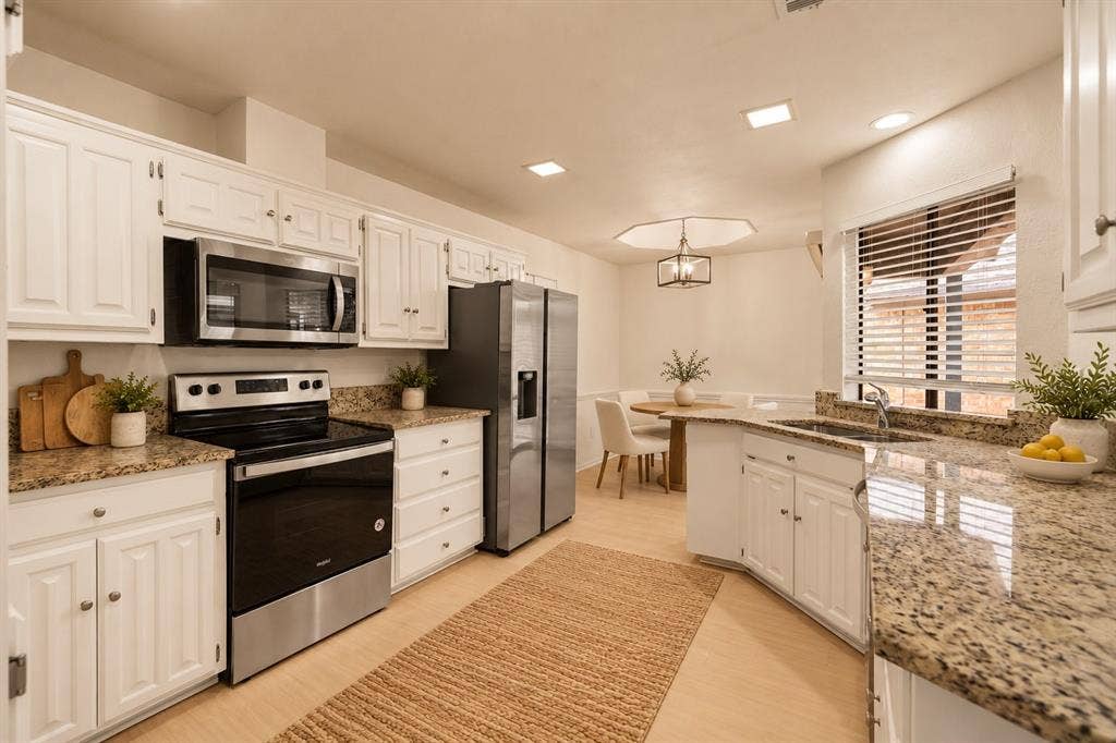 2713 Belmeade Drive, Carrollton, TX 75006 Kitchen open to the breakfast nook. Virtually staged.
