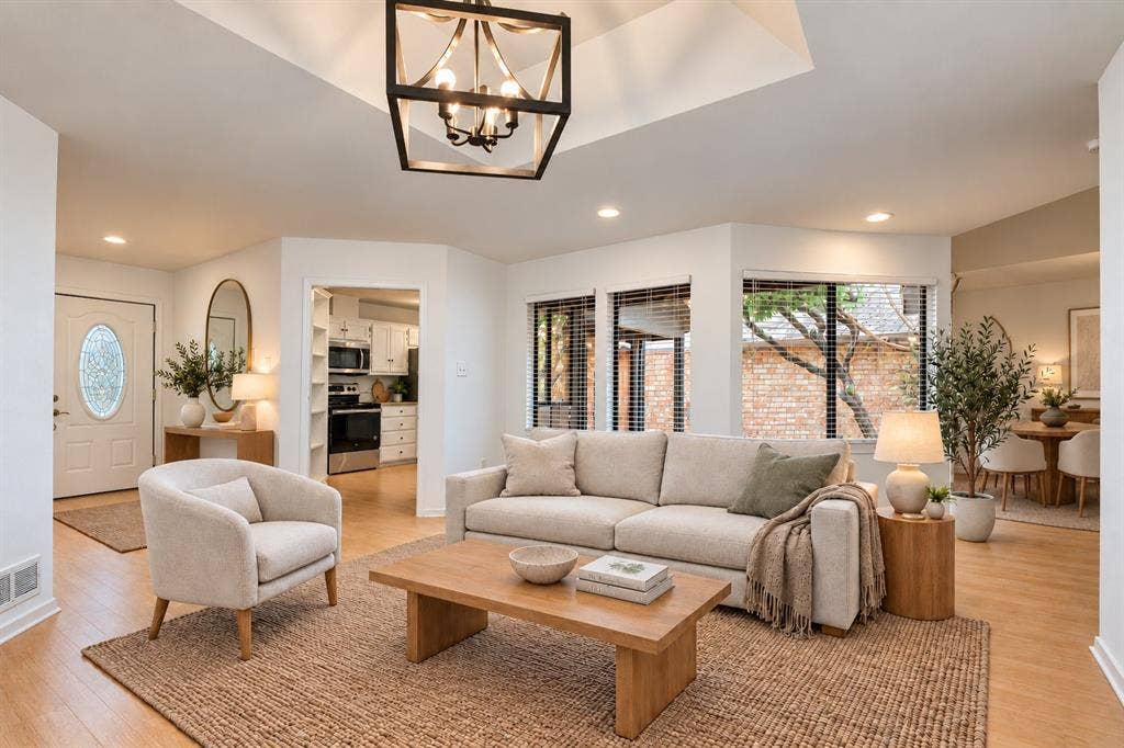 2713 Belmeade Drive, Carrollton, TX 75006 Main living area open to the kitchen. Virtually staged.