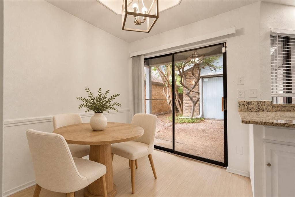 2713 Belmeade Drive, Carrollton, TX 75006 Breakfast nook with a sliding door to the courtyard. Virtually staged.