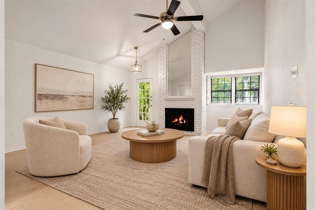 2713 Belmeade Drive, Carrollton, TX 75006 Living room with brick fireplace and vaulted ceiling. Virtually staged.