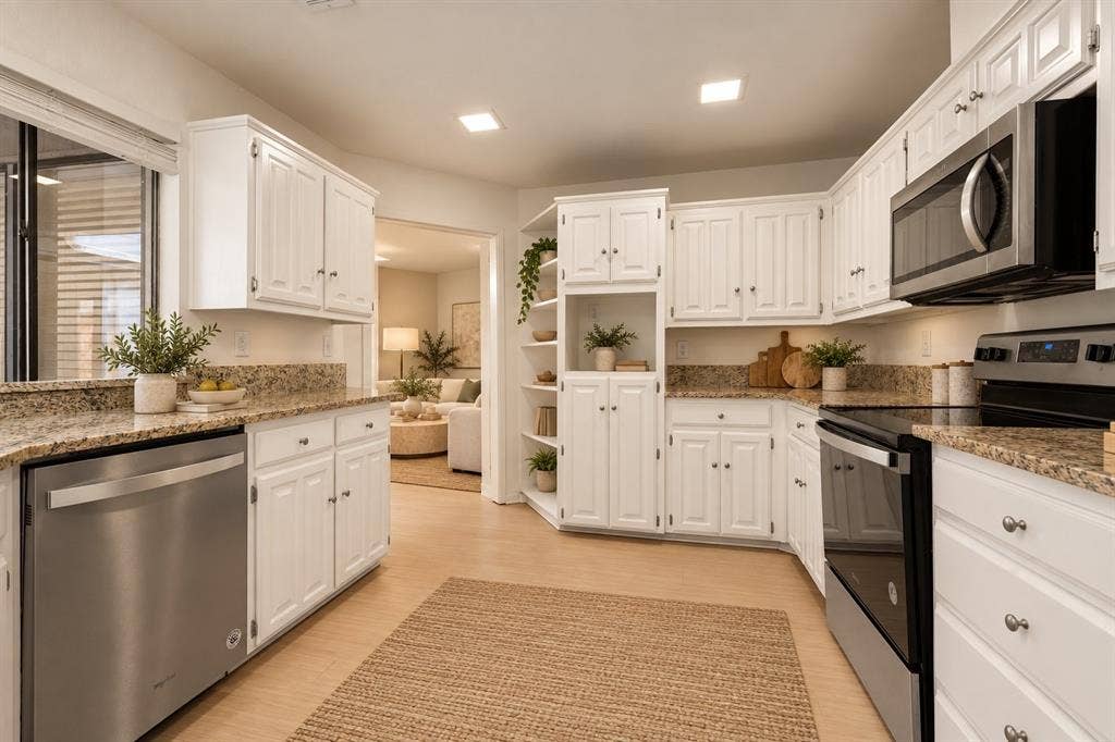 2713 Belmeade Drive, Carrollton, TX 75006 Kitchen with granite counters and stainless appliances. Virtually staged.