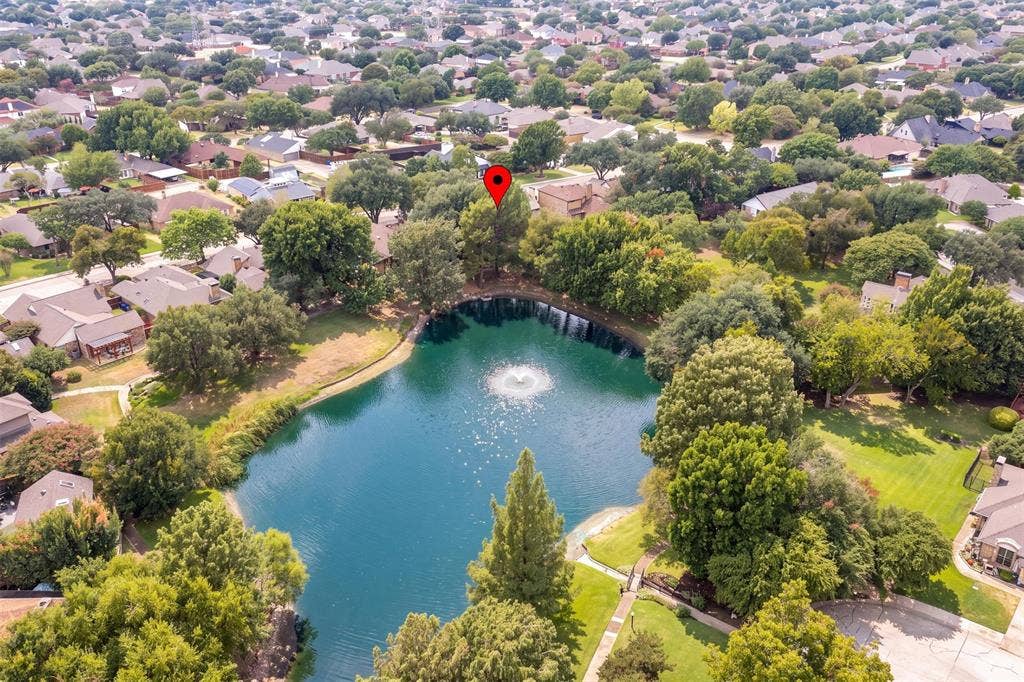 2713 Belmeade Drive, Carrollton, TX 75006 Aerial view showing the home and the neighborhood pond.