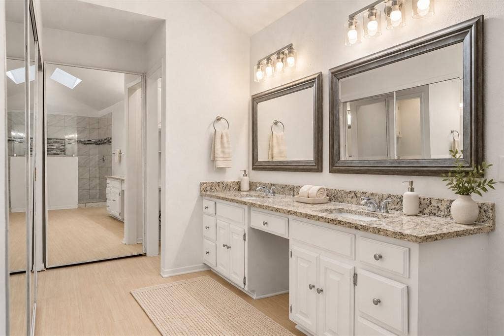 2713 Belmeade Drive, Carrollton, TX 75006 Primary bath with mirrored closet doors. Virtually staged.