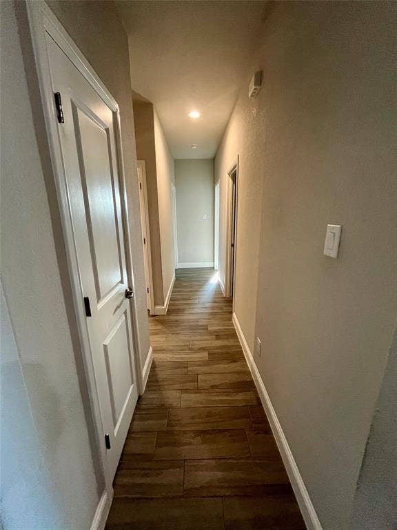 3636 Wintergreen Street, Grand Prairie, TX 76065 Hallway featuring wood-finish flooring, white six-panel doors, neutral wall finishes, and recessed lighting throughout
